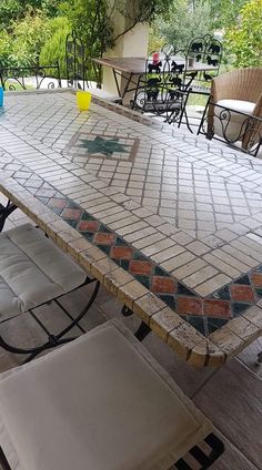 an outdoor table and chairs on a patio