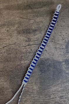 a blue and white string on top of a wooden table