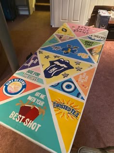 a long table covered in lots of different colored stickers on top of carpeted floor