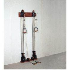 two skis are hanging on the wall and one is upside down with chains attached to it