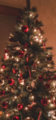 a decorated christmas tree with red and silver ornaments