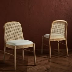 two chairs sitting next to each other on top of a wooden floor