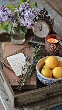 a tray that has some lemons and lavender in it on top of a table