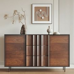 a wooden cabinet sitting in front of a white wall