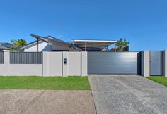 a house with a fence and grass in front of it