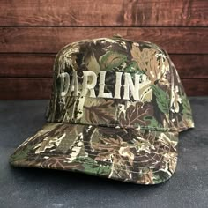 Vintage Style Darlin' Embroidered Camouflage Canvas Snapback Trucker Rope Hat with Free Shipping. White stitched text/logo. Condition is "New with tags". Shipped with USPS First Class. Step into the world of the great outdoors with our Darlin' Stitched Green Camouflage Canvas Rope Hat. With its camo canvas, this hat exudes rustic charm and pays tribute to the iconic country music legends. Plus, enjoy free shipping on this vintage-inspired accessory that's perfect for any country music enthusiast Camo Trucker Hat, Embroidered Baseball Caps, Text Logo, Music Legends, Embroidered Design, Baby Bag, First Class, Hat Designs, Vintage Stil