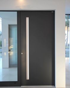 a modern door with glass panels and an illuminated handle on the front entrance to a house