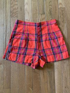 27" waist//Vintage 90s does 60s High Waist Plaid Shorts  Orange plaid shorts with zipper detail along the side of legs. Zipper up back.  Waist 27" Hips 38" Rise 13" Inseam 2" Length 13" Preppy twee professional retro Retro Short Leg Bottoms With Pockets, Retro High Waist Shorts With Belt Loops, Retro Bottoms With Pockets And Short Legs, Retro Shorts With Pockets, Retro Fitted Short Bottoms, Retro Shorts With Belt Loops, Retro High-waisted Shorts With Belt Loops, Retro Fitted Shorts, Retro High-waist Cotton Shorts