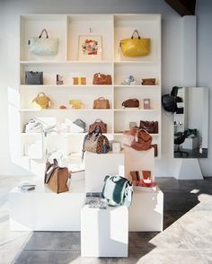 a room filled with lots of purses and handbags