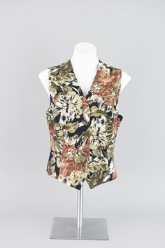 Lovely all over floral pattern fitted vest in black, olive green and a mauve pink-coral tones. Small brown colored buttons down the front. Lightweight blend of textured linen and cotton. The inside is lined in silky black fabric for comfort.  Brand Rafaella // 90s era Condition Great condition No rips, tears or stains Lightly steam cleaned for freshness Dry clean only Smoke free home Size Women's Medium Measurements Shoulder to shoulder - 13" Arm opening - 10" Bust - 36 - 38" Waist - 35" Hips - 36" Length front - 23" Length back - 21" Materials  55% Linen, 45% Cotton ♡ Tid Bit More Info ♡ Please check measurements carefully, vintage sizing can vary from modern day sizing. Measurements are taken on the outside of the garment while lying flat and then doubled. If the garment is stretchy the 90s Jean Dress, Waistcoat Top, Linen Waistcoat, 90s Vest, Pattern Vest, Fitted Vest, Floral Vest, Winter Knitwear, Floral Vests