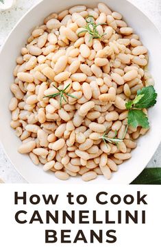 a white bowl filled with cannellini beans and garnished with fresh herbs