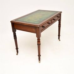 an old wooden table with green glass top