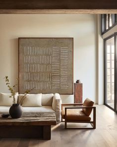 a living room filled with furniture and a painting on the wall