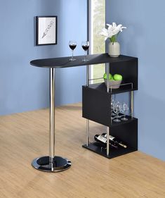 a black table with two wine glasses on it and a glass holder in the middle