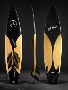 two surfboards with yellow and black designs on them