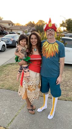 a man and woman in costume standing next to each other on a sidewalk with cars parked behind them