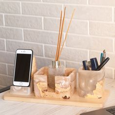 a cell phone is sitting on a desk next to an organizer