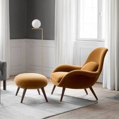 an orange chair and ottoman in a living room