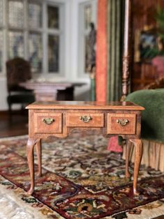 a small wooden table sitting on top of a rug