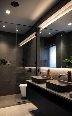 a bathroom with two sinks and a large mirror in the wall next to each other