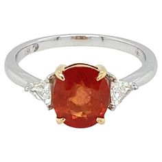 This beautiful orange sapphire ring is adorned with two trillion east west diamonds. Crafted in 18K two tone gold symbolizes luxury and grace. Perfect for all occasions and can be cherished for ages. Weight of Sapphire: 2.07 Carat Weight of Diamond: 0.283 Carat Gold: 18K Two Tone Size: 7 Orange Sapphire Ring, Platinum Diamond Engagement Rings, Spinel Ring, Orange Sapphire, Platinum Engagement Rings, Modern Ring, Sapphire Stone, Baguette Diamond, East West