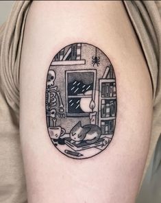 a black and white photo of a cat in a window tattoo on the right thigh