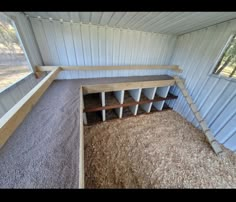 the inside of a shed with several bins in it