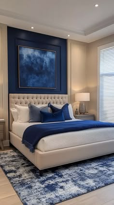 a large blue and white bed in a bedroom