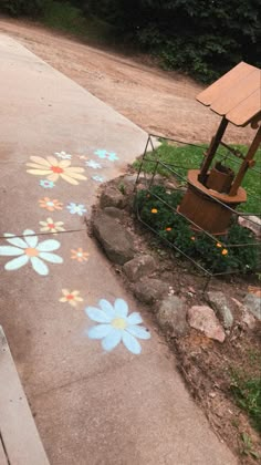 the sidewalk has flowers painted on it