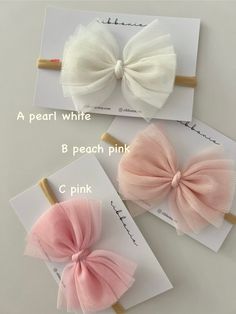 three different types of hair bows on top of each other, one pink and one white