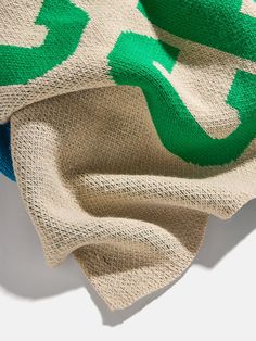 a blanket with green arrows on it