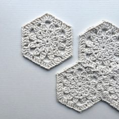 two crocheted hexagons are shown on a white surface with the same pattern