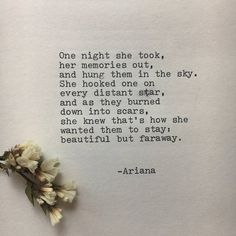 a piece of paper with a poem written on it and some flowers laying next to it