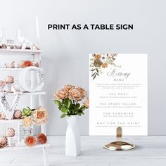 a table sign sitting next to a vase with flowers