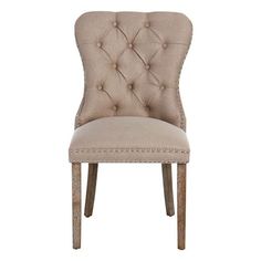 a beige upholstered chair with buttons on the back and legs, against a white background