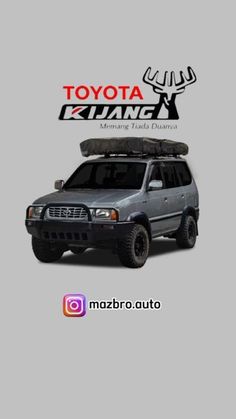 the toyota kluang suv is parked in front of a gray background with an image of