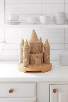 a sand castle sitting on top of a white counter