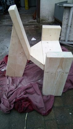 a wooden chair sitting on top of a tarp