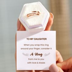 someone is holding up a card with a ring on it that says, to my daughter when you wrap this ring around your finger, consider it from me to you with love & kisses