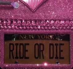 a pink license plate with the word ride or die on it