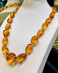 Natural Citrine fine Quality fancy Tumble Shape Necklace with 23 pieces high-End quality Gems by GemShopOnline. These rich color beauty gemstone is hand cut in different sizes & carefully lined up. They are cut in smooth fancy tumble  shape. A special cut that makes these amazing quality gemstones unique. The large necklace is almost eye clean (hardly it will show minor inclusions in some pieces) and is beautifully crystal like clear. It is string with lobster clip & ready to wear.  For safety! Luxury Unique Citrine Necklaces, Luxury Amber Necklace With Gemstone Beads, Luxury Faceted Citrine Necklaces, Luxury Multi-stone Orange Jewelry, Elegant Luxury Amber Crystal Necklaces, Luxury Amber Gemstone Necklace, Amber Gemstone, Artisan Bracelets, Large Necklace