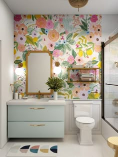 a bathroom with flowers on the wall and a mirror over the sink in front of it