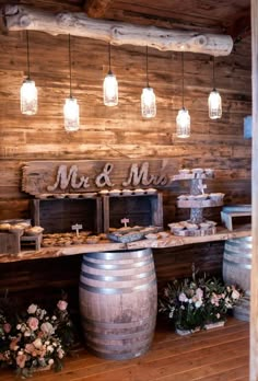 a wooden table topped with lots of bottles and vases filled with flowers on top of it