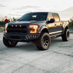 a black truck parked on top of a parking lot