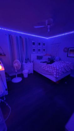 a bedroom with purple lighting and a bed in the middle is lit up by blue lights