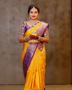 a woman in a yellow and purple sari