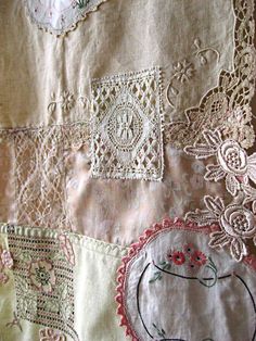 a close up of a piece of cloth with embroidered flowers and laces on it