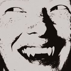 a black and white photo of a smiling man's face with his mouth open