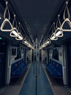 an empty subway car with several lights hanging from it's ceiling and the doors open