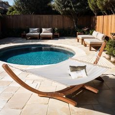 a hammock sitting next to a swimming pool